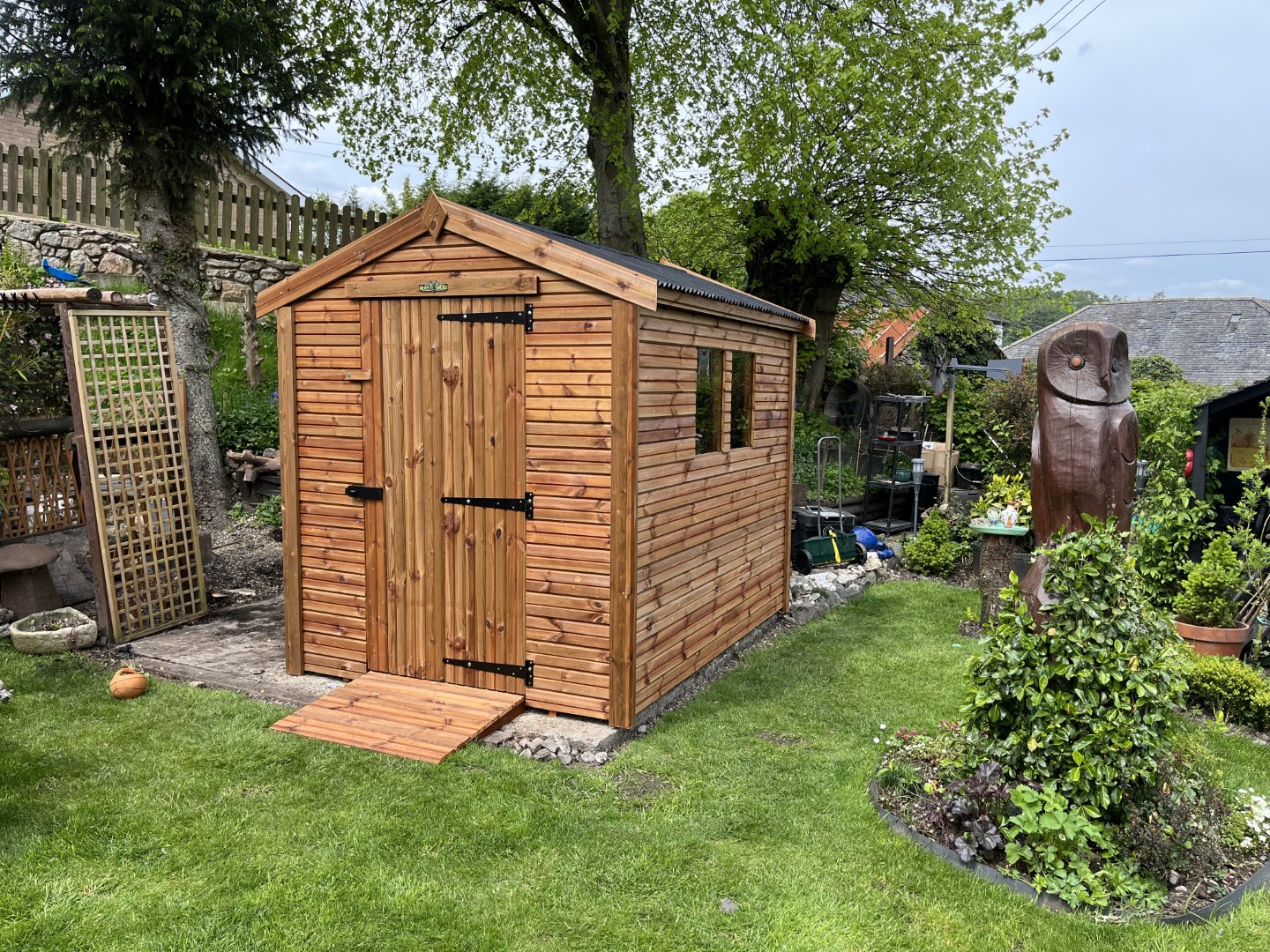 Tanalised wooden garden shed installed in a landscaped garden