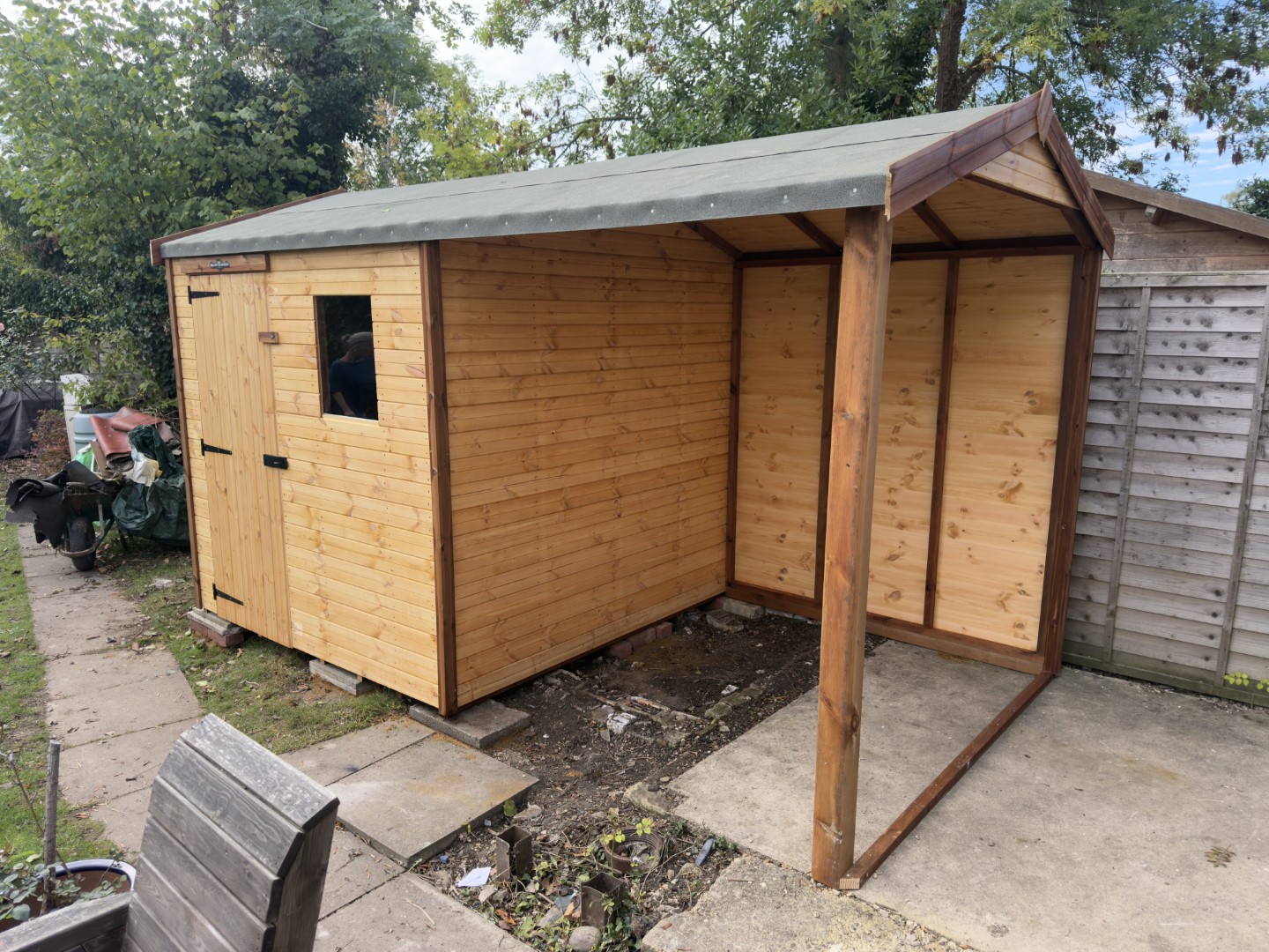 Bespoke wooden shed with a covered side extension