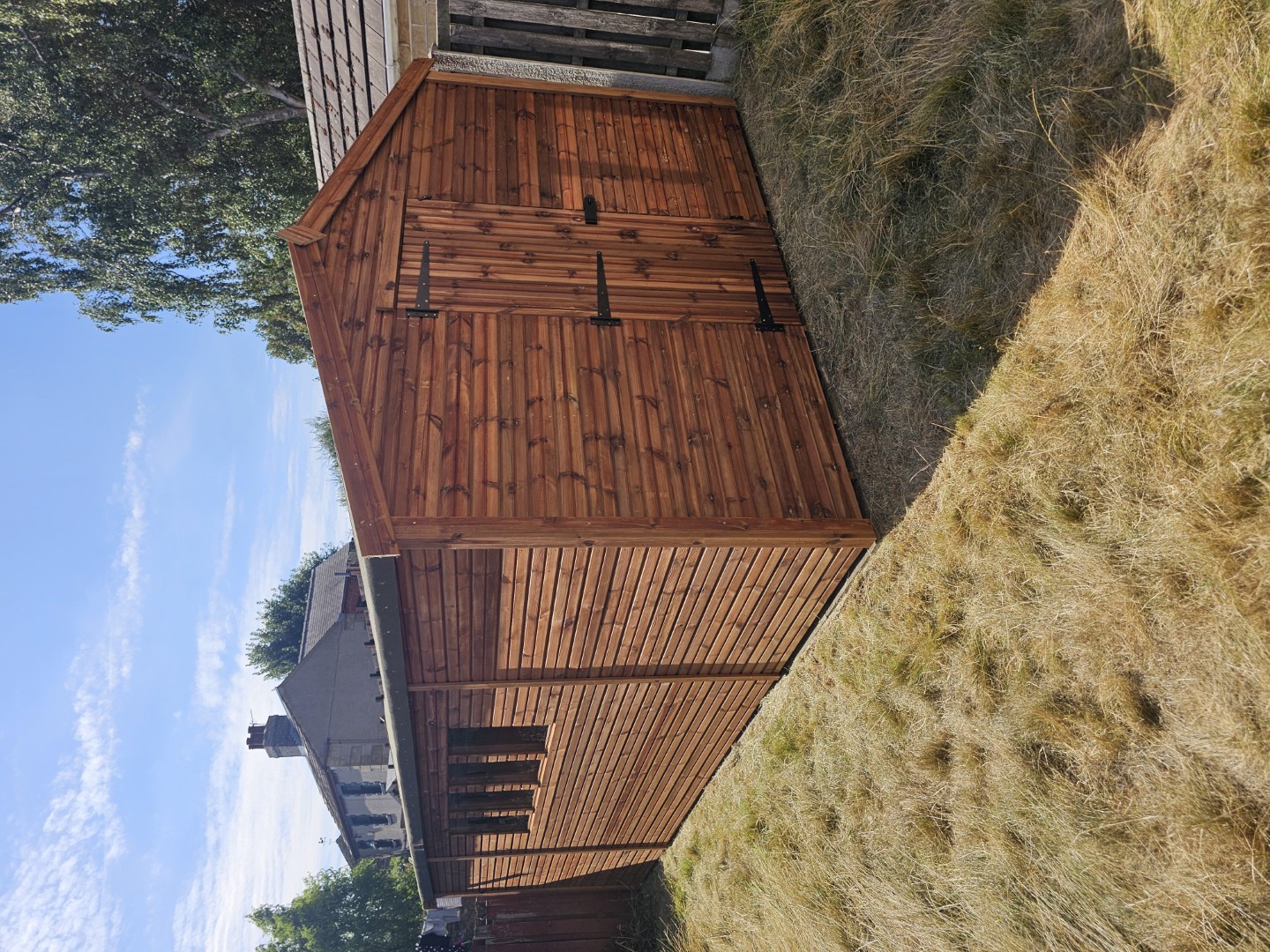 Large bespoke wooden shed with custom window and door arrangement