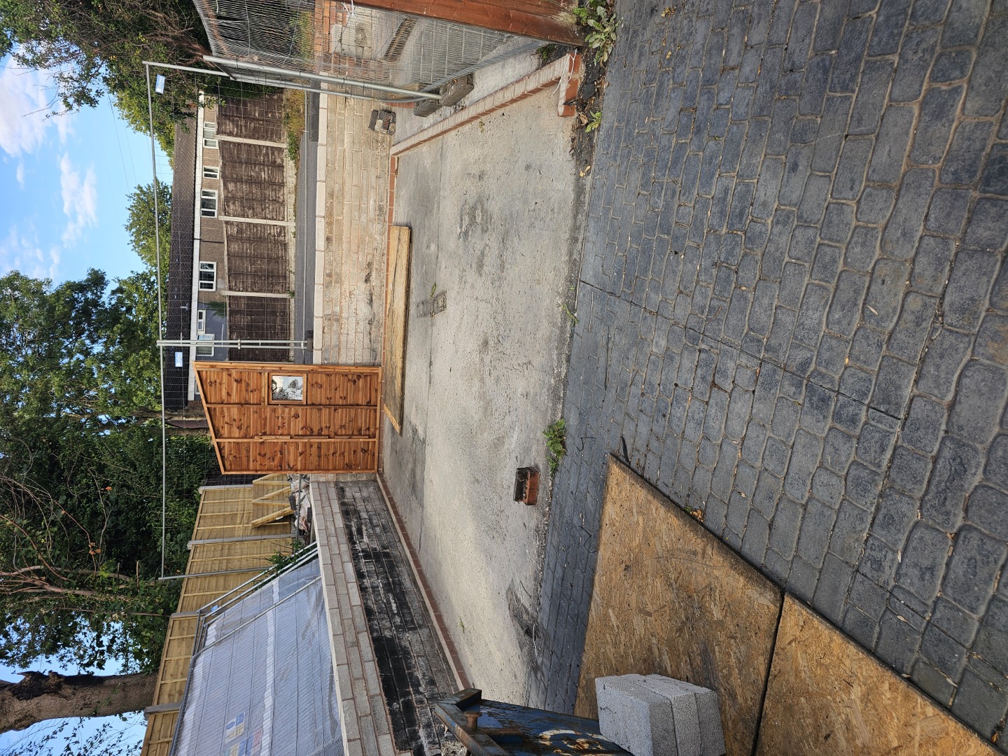 Custom garage during installation with the wide front opening visible