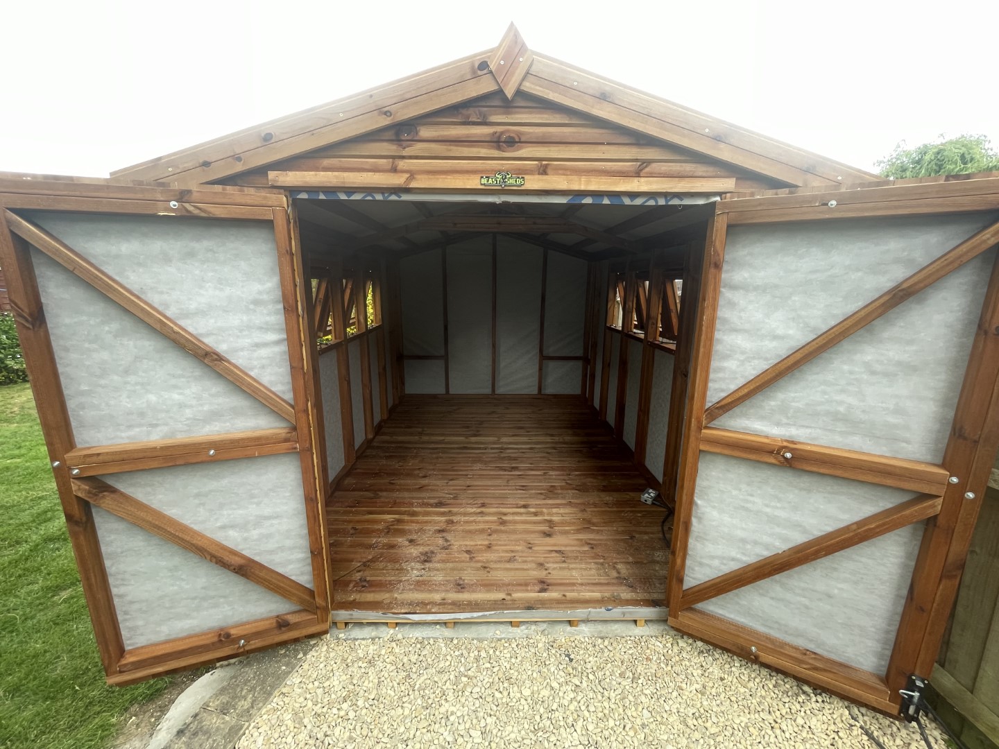 Breathable membrane lining and timber floor inside the Birmingham workspace shed