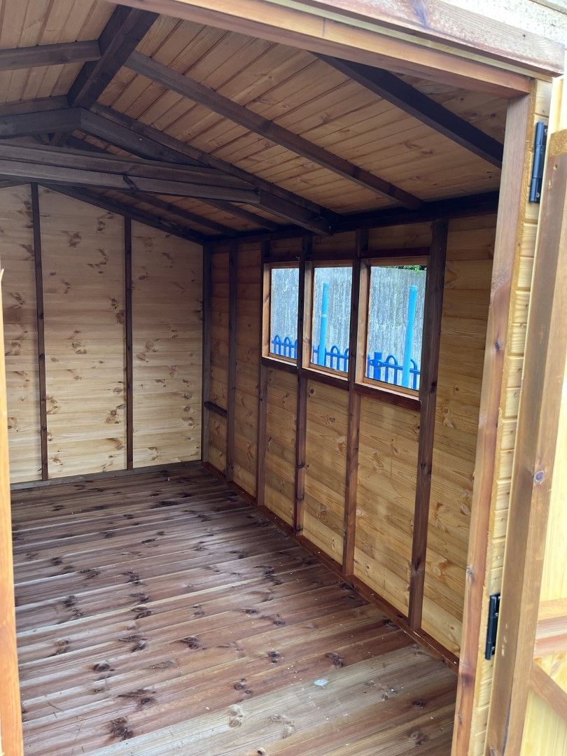 Three windows bringing natural light into the school storage shed