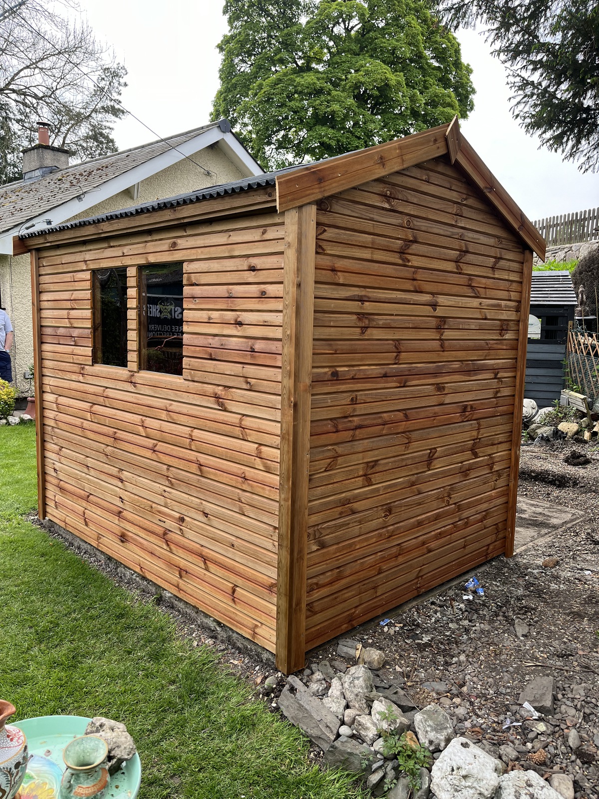 Side view of the shed showing the two windows and neat cladding finish