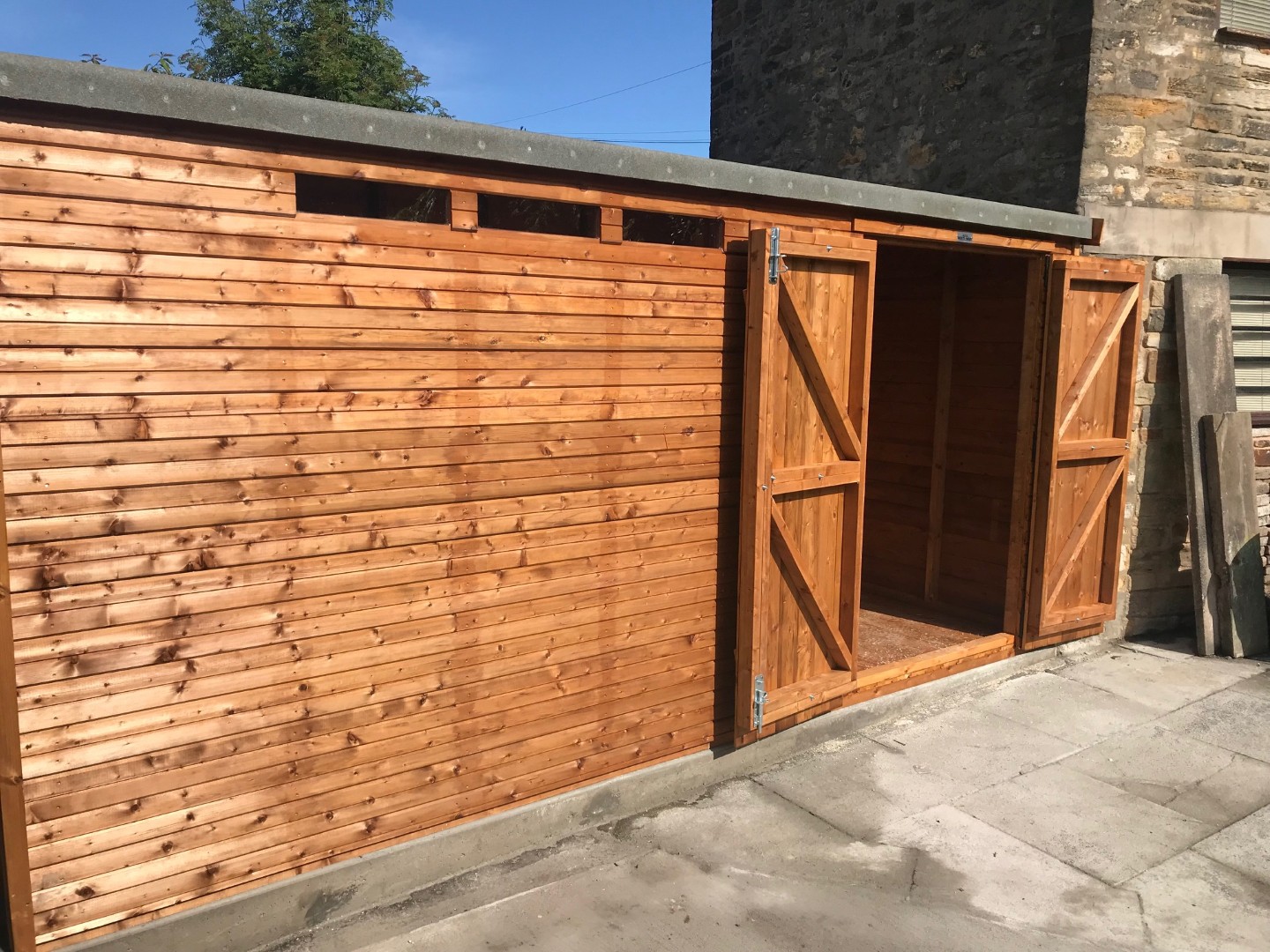 Double doors open to show the wide access into the Liverpool builder storage shed