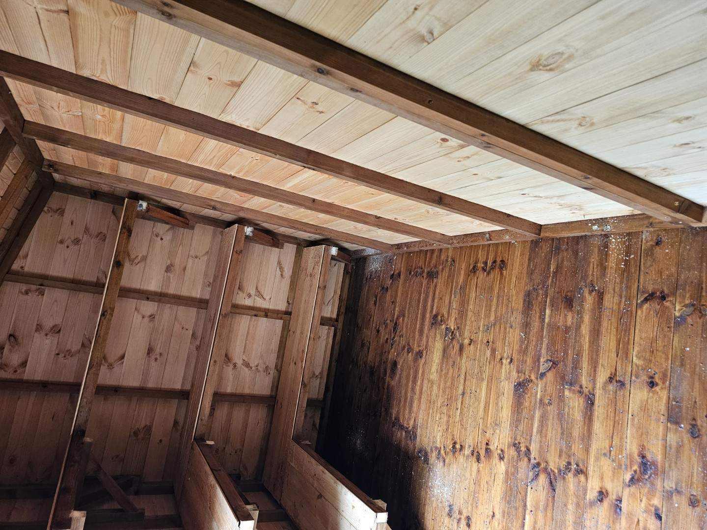 Wide interior view showing the extensive shelving inside the Northampton playgroup shed