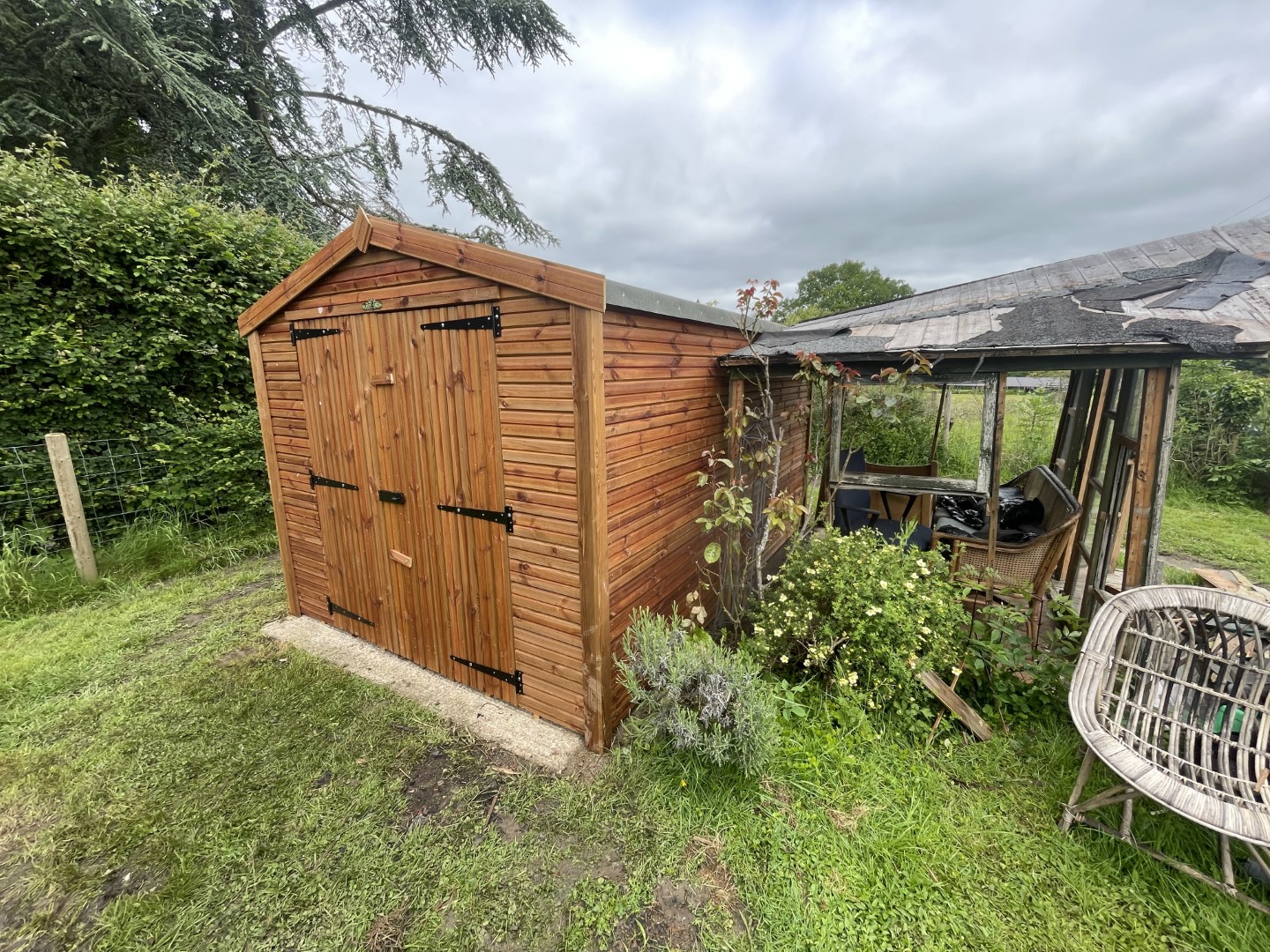 The shed positioned on the existing slab beside the covered seating area