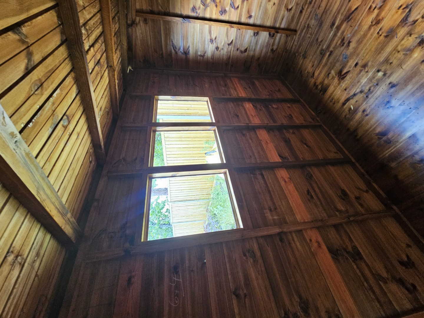Three windows providing natural light inside the Solihull garden shed