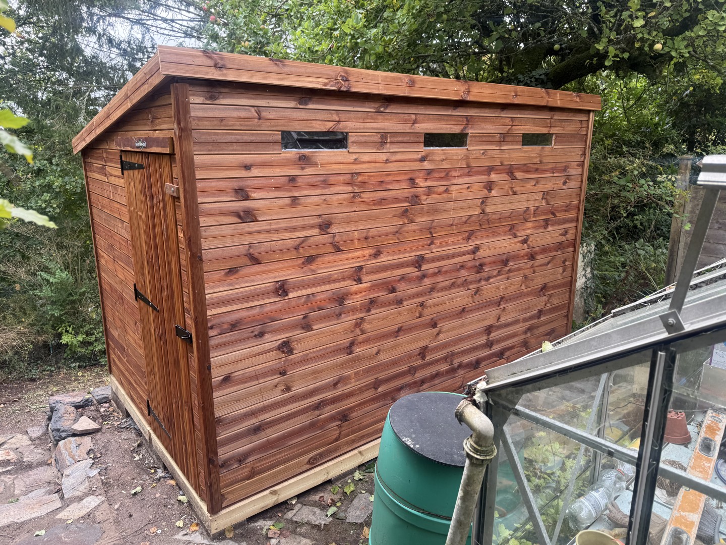 11 by 7 Pent Tanalised shed installed beside a stone retaining wall in Stoke on Trent
